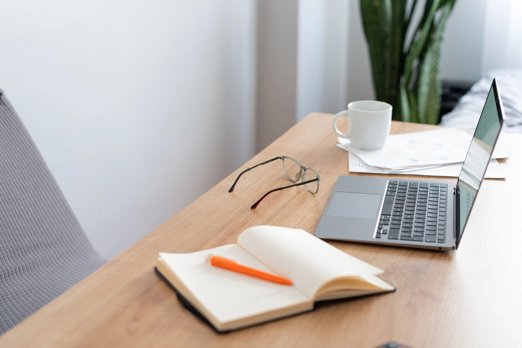 Organized desk with notebook and laptop for practical planning