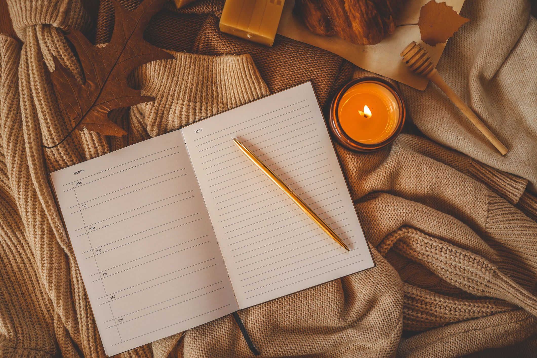 Open weekly planner and pen on a desk